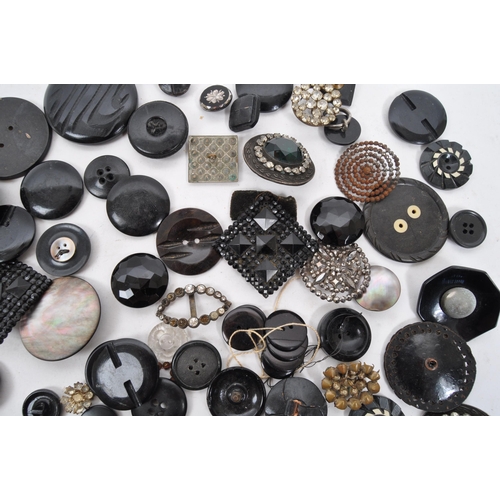 329 - A collection of 20th Century vintage monochrome buttons including 1920s Art Deco examples with later... 