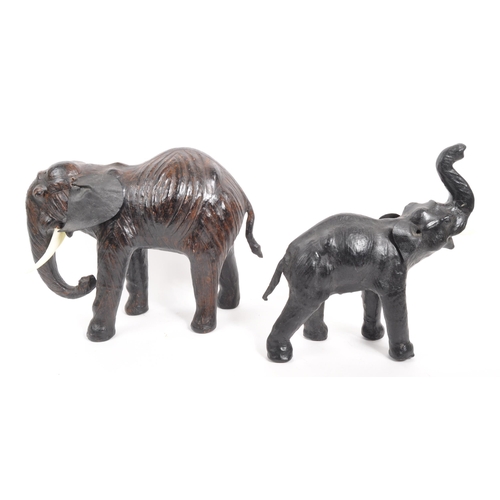 331 - Two papier-mâché elephants. Two standing elephants with plastic tusks, one weather faux leather ears... 