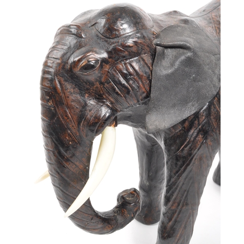 331 - Two papier-mâché elephants. Two standing elephants with plastic tusks, one weather faux leather ears... 