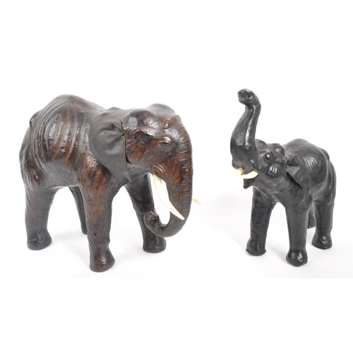 331 - Two papier-mâché elephants. Two standing elephants with plastic tusks, one weather faux leather ears... 