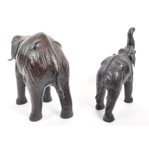 331 - Two papier-mâché elephants. Two standing elephants with plastic tusks, one weather faux leather ears... 