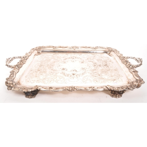 335 - An early 20th century silver plated serving tray. Twin handle, with foliate and floral design to rim... 