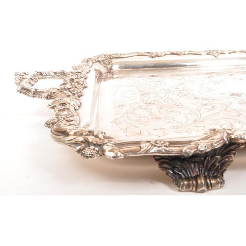 335 - An early 20th century silver plated serving tray. Twin handle, with foliate and floral design to rim... 