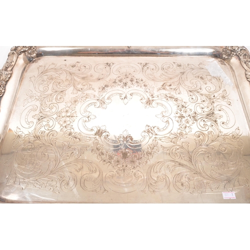 335 - An early 20th century silver plated serving tray. Twin handle, with foliate and floral design to rim... 