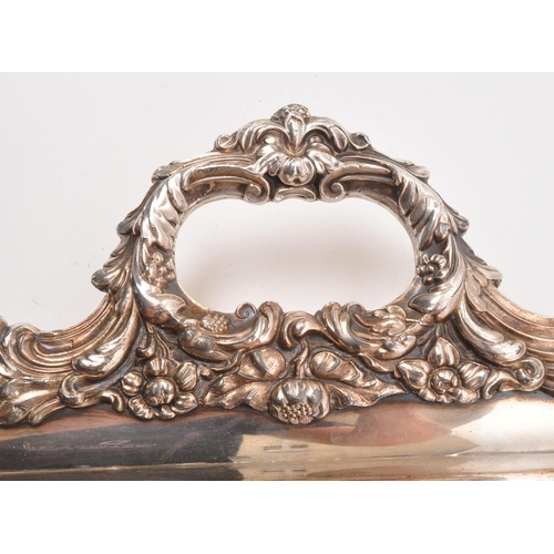 335 - An early 20th century silver plated serving tray. Twin handle, with foliate and floral design to rim... 