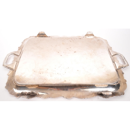 335 - An early 20th century silver plated serving tray. Twin handle, with foliate and floral design to rim... 