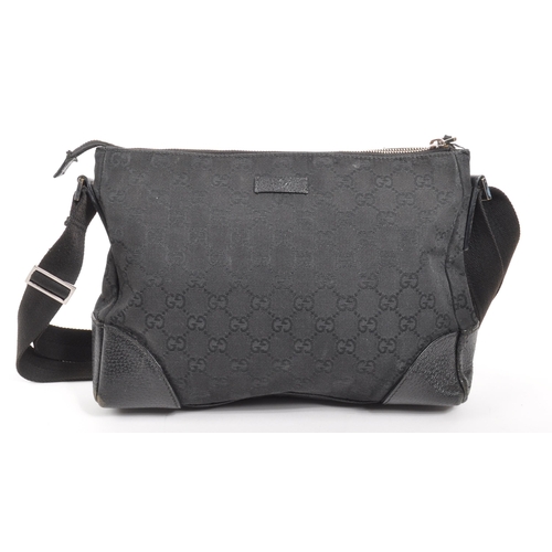 340 - Gucci - A Gucci GG black canvas shoulder / handbag. The bad having leather trim to corners, with bla... 