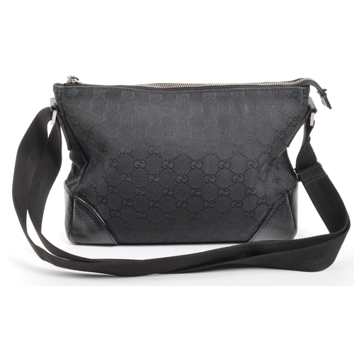 340 - Gucci - A Gucci GG black canvas shoulder / handbag. The bad having leather trim to corners, with bla... 