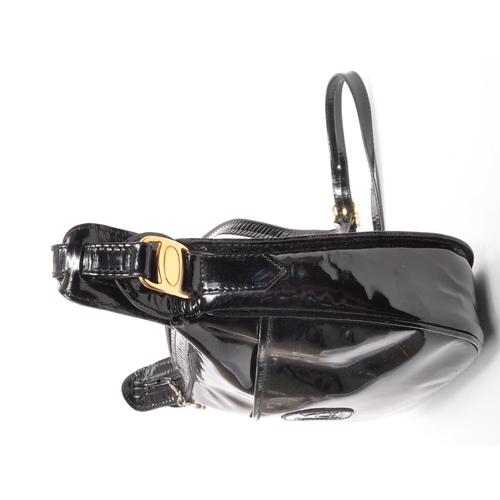 341 - Russell & Bromley - A black patent leather Russell & Bromley handbag. The handbag having impressed R... 