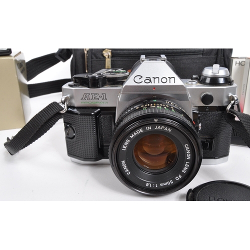 347 - Canon - A late 20th century Canon AE-1 Program 35mm SLR camera with lenses and accessories. The came... 