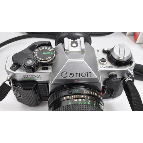 347 - Canon - A late 20th century Canon AE-1 Program 35mm SLR camera with lenses and accessories. The came... 