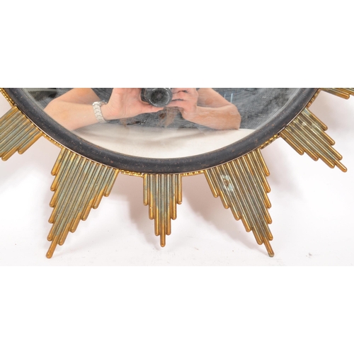 350 - A mid Century circa 1960s sunburst circular mirror with brass surround. Measuring approximately 48cm... 