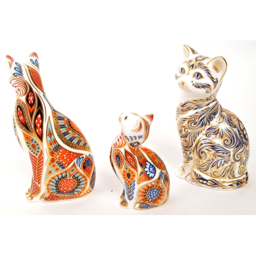 47 - Royal Crown Derby - A collection of three porcelain china Royal Crown Derby paperweight cat figures ... 