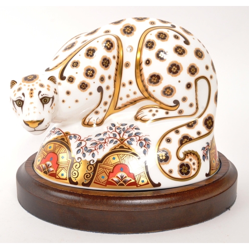 6 - Royal Crown Derby - A porcelain china Royal Crown Derby Snow Leopard paperweight figure with gold st... 