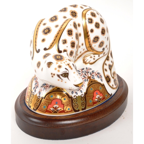 6 - Royal Crown Derby - A porcelain china Royal Crown Derby Snow Leopard paperweight figure with gold st... 