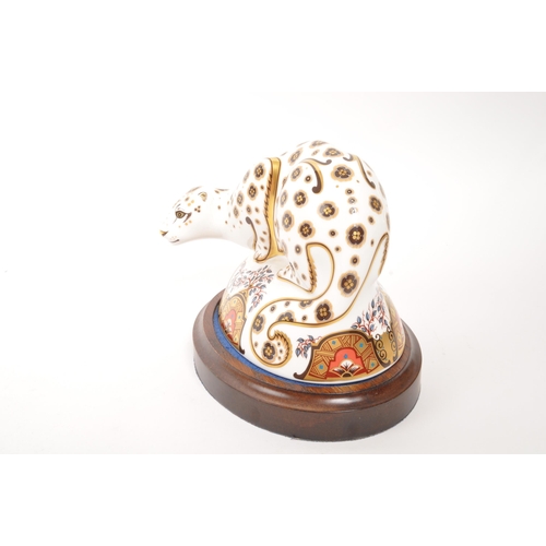 6 - Royal Crown Derby - A porcelain china Royal Crown Derby Snow Leopard paperweight figure with gold st... 