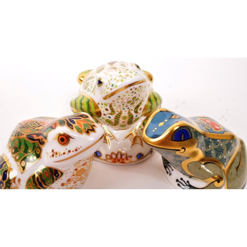 60 - Royal Crown Derby - A collection of three porcelain china Royal Crown Derby paperweight frog figures... 