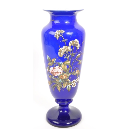 66 - A large early 20th Century cobalt blue opaque vase having hand painted floral spray to front on circ... 