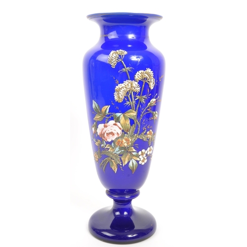 66 - A large early 20th Century cobalt blue opaque vase having hand painted floral spray to front on circ... 