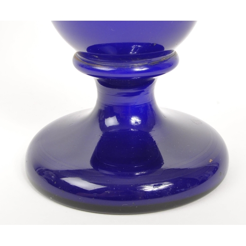 66 - A large early 20th Century cobalt blue opaque vase having hand painted floral spray to front on circ... 