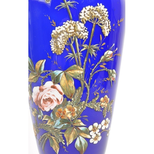 66 - A large early 20th Century cobalt blue opaque vase having hand painted floral spray to front on circ... 