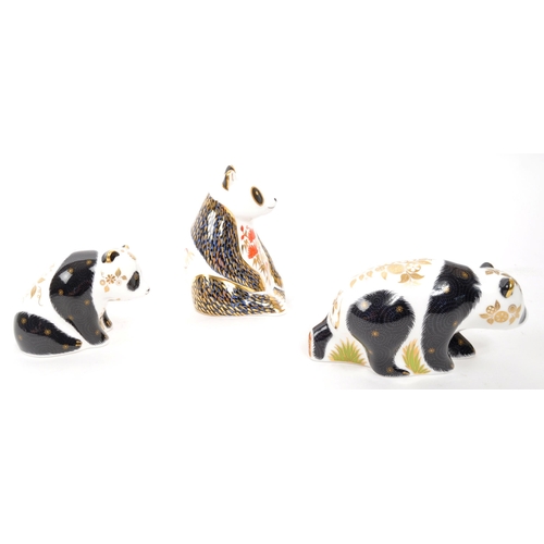 82 - Royal Crown Derby - A collection of three porcelain china Royal Crown Derby paperweight panda figure... 