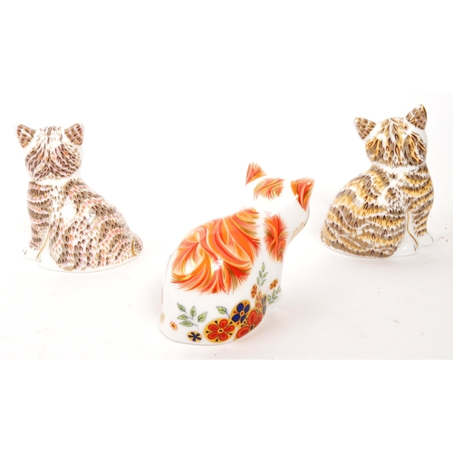 83 - Royal Crown Derby - A collection of three porcelain china Royal Crown Derby paperweight cats figures... 