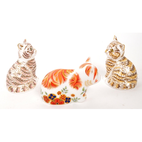 83 - Royal Crown Derby - A collection of three porcelain china Royal Crown Derby paperweight cats figures... 