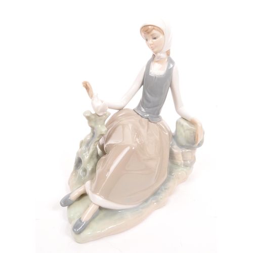 97 - Nao for Lladro / Royal Doulton - A collection of five porcelain china figurines comprising of four N... 