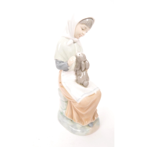 97 - Nao for Lladro / Royal Doulton - A collection of five porcelain china figurines comprising of four N... 