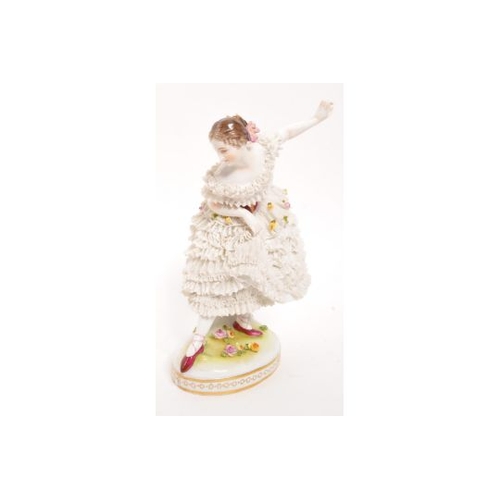 115 - Volkstedt - An early 20th Century German porcelain china Volkstedt crinoline figurine in the form of... 