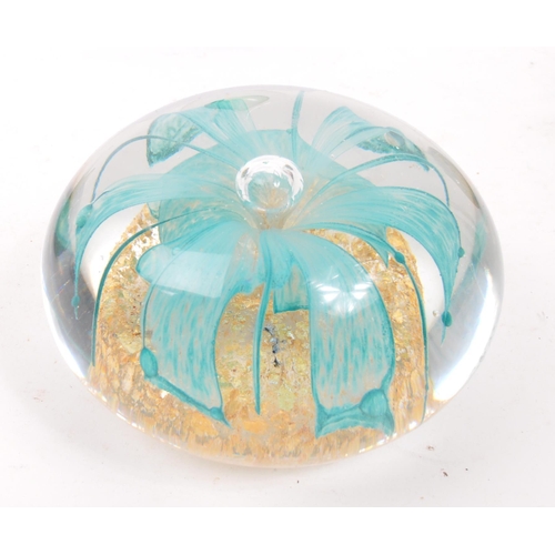 10 - A collection of four 20th Century studio glass paperweights to include one of teardrop shape with gr... 