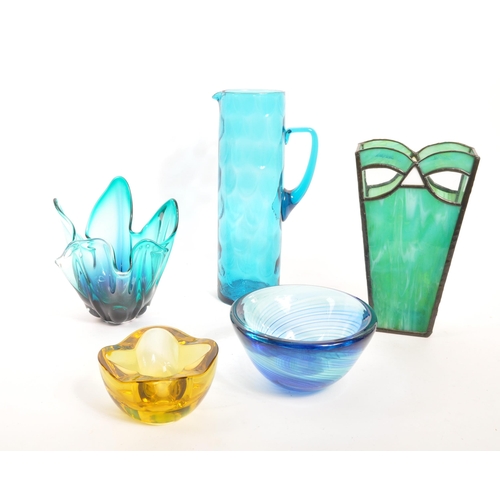 104 - A collection of 20th Century studio glass items comprising of tall jug, circular bowl signed to base... 