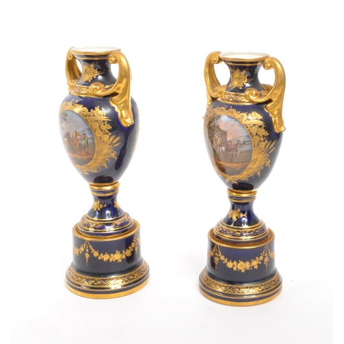 110 - Dresden - A pair of late 19th Century Dresden porcelain twin handled vases having cobalt ground with... 