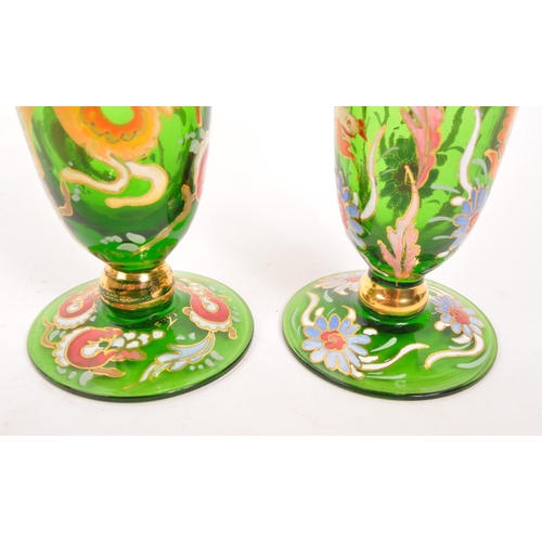 130 - A pair of bohemian 20th Century vintage green glass and enamel vases each having floral animal desig... 