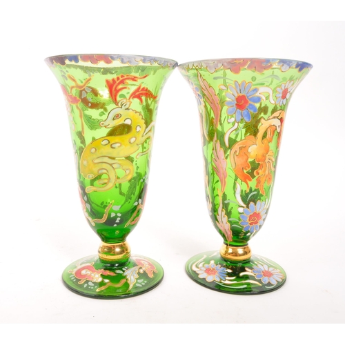 130 - A pair of bohemian 20th Century vintage green glass and enamel vases each having floral animal desig... 