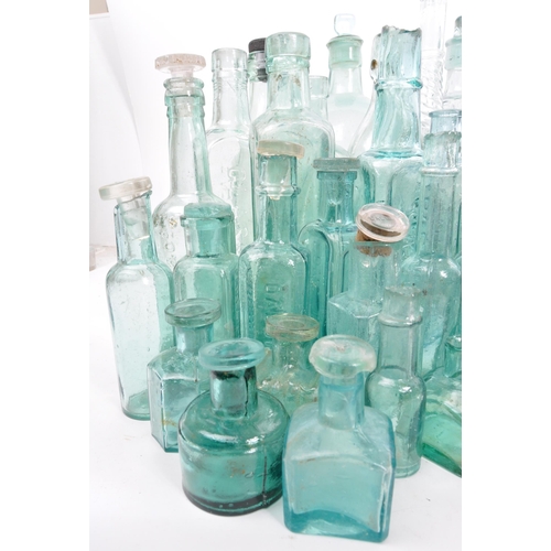 134 - A large collection of early 20th Century and later coloured glass bottles to include medicinal and p... 