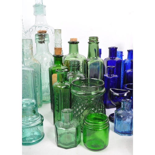 134 - A large collection of early 20th Century and later coloured glass bottles to include medicinal and p... 