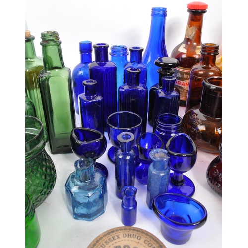 134 - A large collection of early 20th Century and later coloured glass bottles to include medicinal and p... 