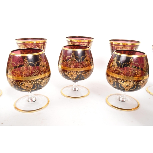 146 - A collection of 20th Century Venetian Amethyst glasses with gilt floral motif and gilt rims. Compris... 