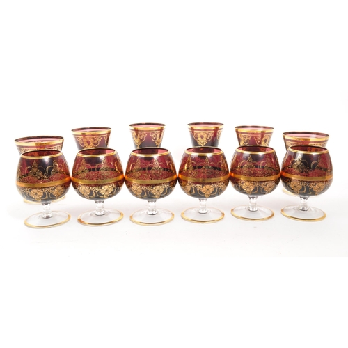 146 - A collection of 20th Century Venetian Amethyst glasses with gilt floral motif and gilt rims. Compris... 