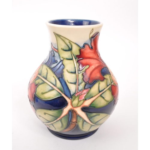 150 - Moorcroft - A china Moorcroft Pottery vase in the ' Simeon ' pattern designed by Philip Gibson and i... 