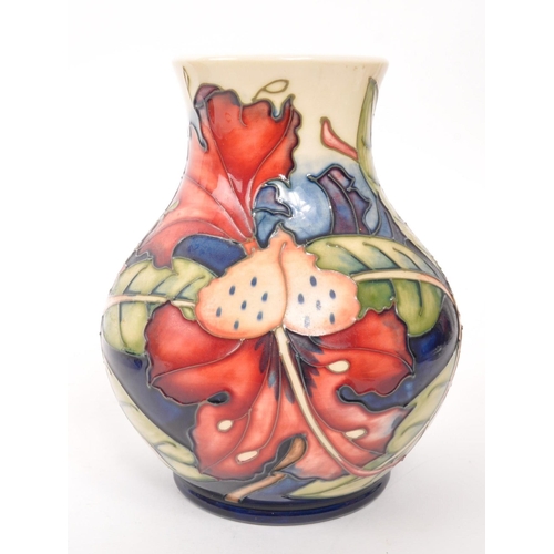 150 - Moorcroft - A china Moorcroft Pottery vase in the ' Simeon ' pattern designed by Philip Gibson and i... 