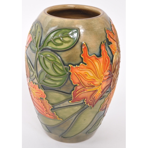 160 - Moorcroft Pottery - A contemporary Flame of the forest ceramic gloss vase. Stamped to underside with... 