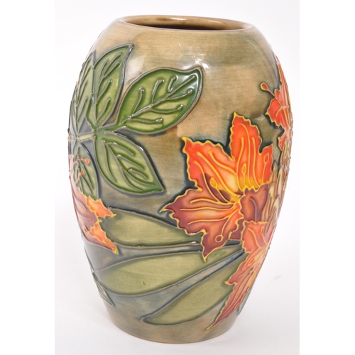 160 - Moorcroft Pottery - A contemporary Flame of the forest ceramic gloss vase. Stamped to underside with... 