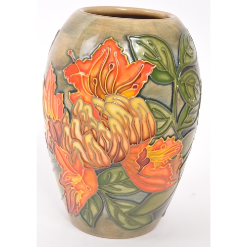 160 - Moorcroft Pottery - A contemporary Flame of the forest ceramic gloss vase. Stamped to underside with... 