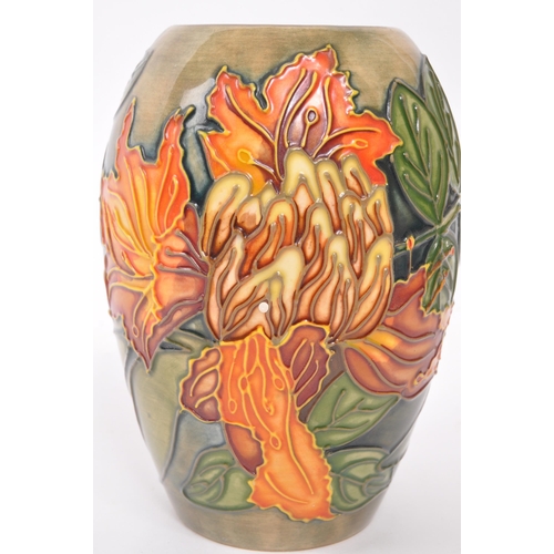 160 - Moorcroft Pottery - A contemporary Flame of the forest ceramic gloss vase. Stamped to underside with... 