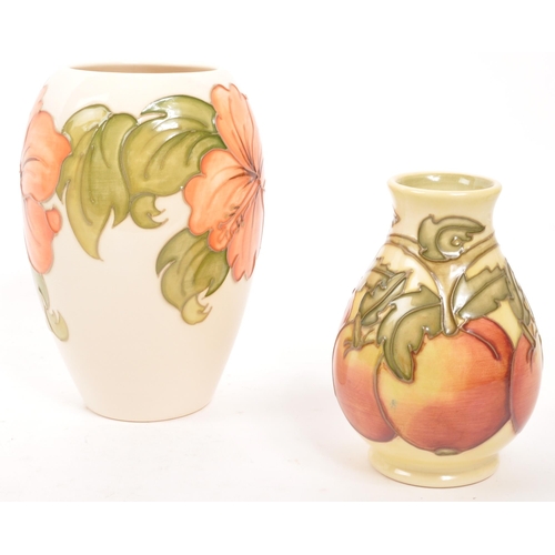 163 - Moorcorft Pottery - Two contemporary ceramic vases. One in the hibiscus pattern in a cream ground wi... 