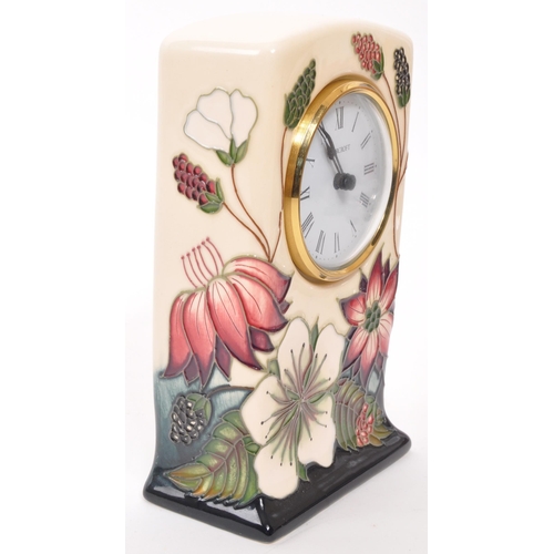 166 - Moorcroft Pottery - A contemporary ceramic mantel clock. Bramble Revisited design with white face, e... 