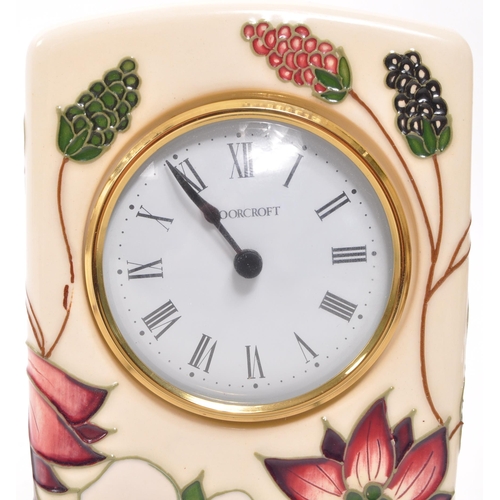 166 - Moorcroft Pottery - A contemporary ceramic mantel clock. Bramble Revisited design with white face, e... 